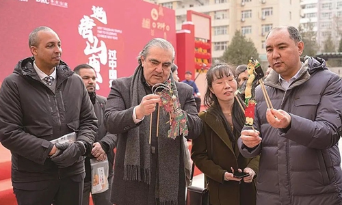 Envoys visit Tangshan Temple Fair held in Beijing on February 24, 2024 and explore the charm of shadow puppets. Photo: Courtesy of Tangshan Culture and Tourism 