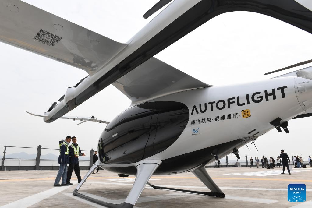 Staff members check the 5-seat eVTOL (electric vertical takeoff and landing) aircraft at Shekou Cruise Home port in Shenzhen, south China's Guangdong Province, Feb. 27, 2024. The eVTOL aircraft, developed by a high-tech company AutoFlight and named as Prosperity, completed its first inter-city electric air-taxi demonstration flight from Shekou Cruise Home port in Shenzhen to Jiuzhou Port in Zhuhai.(Photo: Xinhua)