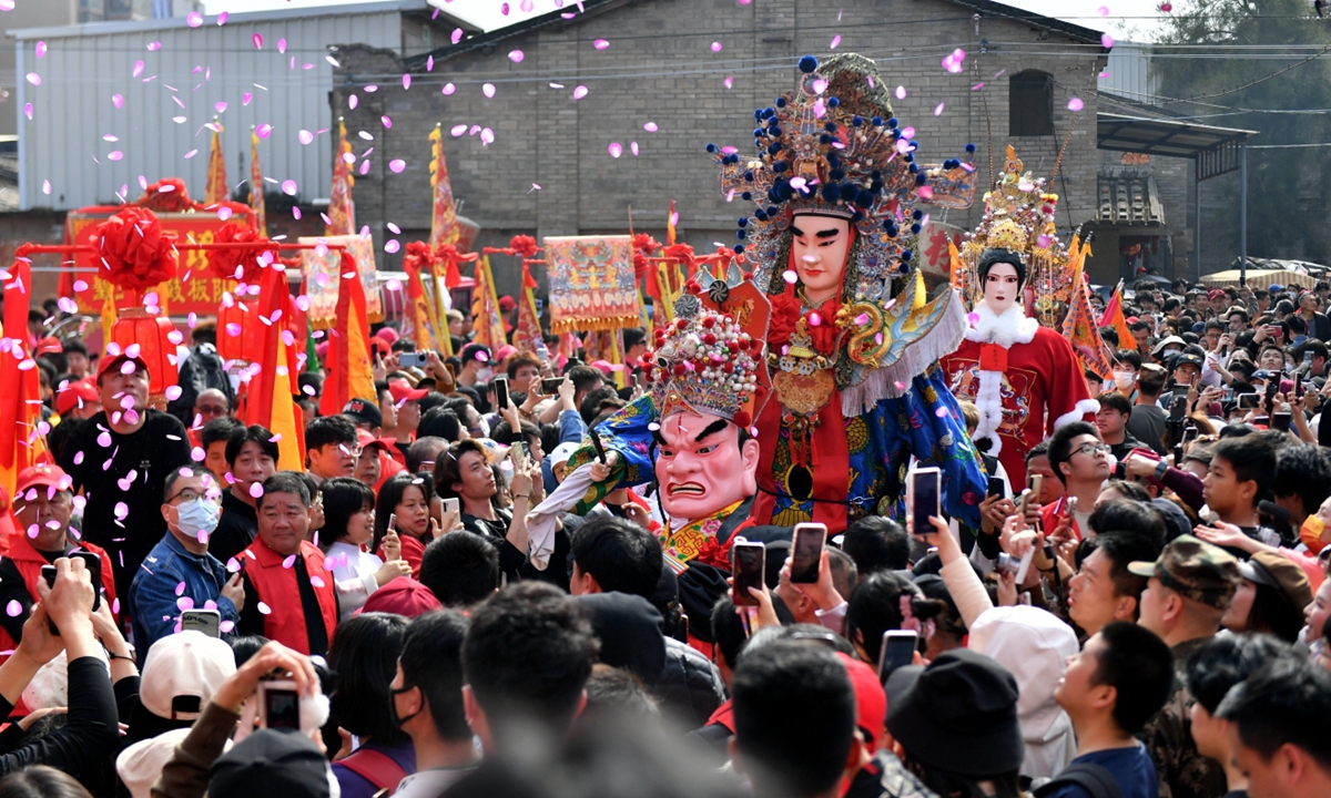 People take part in the traditional folk event known as Youshen, which literally means 