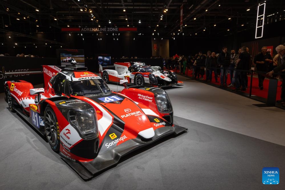 Visitors watch race cars at the 91st Geneva International Motor Show in Geneva, Switzerland, Feb. 28, 2024. The 91st Geneva International Motor Show opened to the public on Feb. 27 and will last until March 3.(Photo: Xinhua)