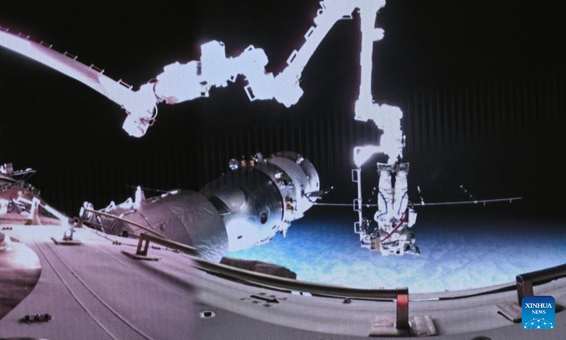 This screen image captured at Beijing Aerospace Control Center on March 2, 2024 shows Shenzhou-17 astronaut Jiang Xinlin performing extravehicular activities assisted by the robotic arm of the space station. The Shenzhou-17 crew members, who are currently on board China's space station, have completed their second extravehicular mission on Saturday. (Photo: Xinhua)