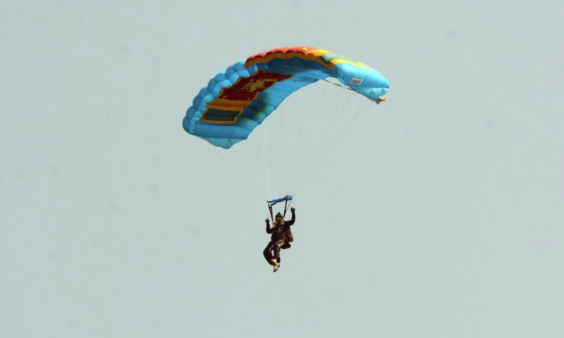 A paratrooper takes part in the Air Tattoo - 2024 technological and educational exhibition in Jaffna, Sri Lanka, on March 9, 2024. The exhibition is scheduled to run from March 6 to 10, in commemoration of the 73rd anniversary of the Sri Lanka Air Force. (Photo by Gayan Sameera/Xinhua)