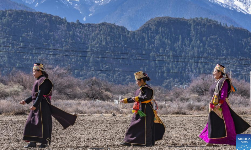 Farmers participate in a ceremony marking the start of spring farming in Gyaimain Village in Qonggyai County of Shannan, southwest China's Xizang Autonomous Region, March 16, 2024. Ceremonies marking the start of spring farming were held in Xizang on Saturday during which farmers held chema (a wooden box filled with colorful grains and barley flour, symbolizing good luck and prosperity in Tibetan culture), sang songs, and toasted each other with barley wine. The ceremony holds great significance as it marks the beginning of a new year's farming season and serves as a prayer for favorable weather and bountiful harvests. It is considered an important ritual in the farming regions of Xizang. (Xinhua/Tenzing Nima Qadhup)