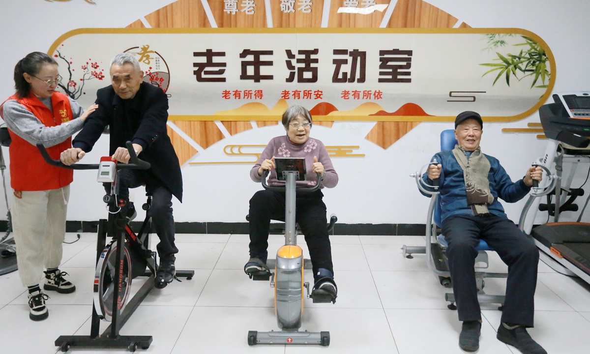 Elderly people exercise at a community activity room for the aged in Yangzhou, East China's Jiangsu Province, on December 15, 2023. Photo: VCG