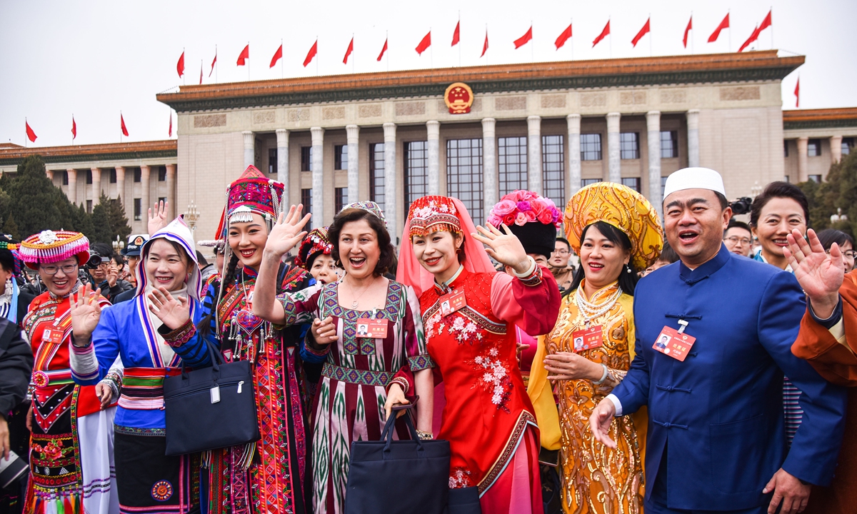 Members of the 14th National Committee of the Chinese People's Political Consultative Conference (CPPCC), in colorful ethnic dress, pose for a group photo outside the Great Hall of the People after the opening meeting of the second session of the 14th CPPCC National Committee in Beijing on March 4, 2024. Photo: VCG