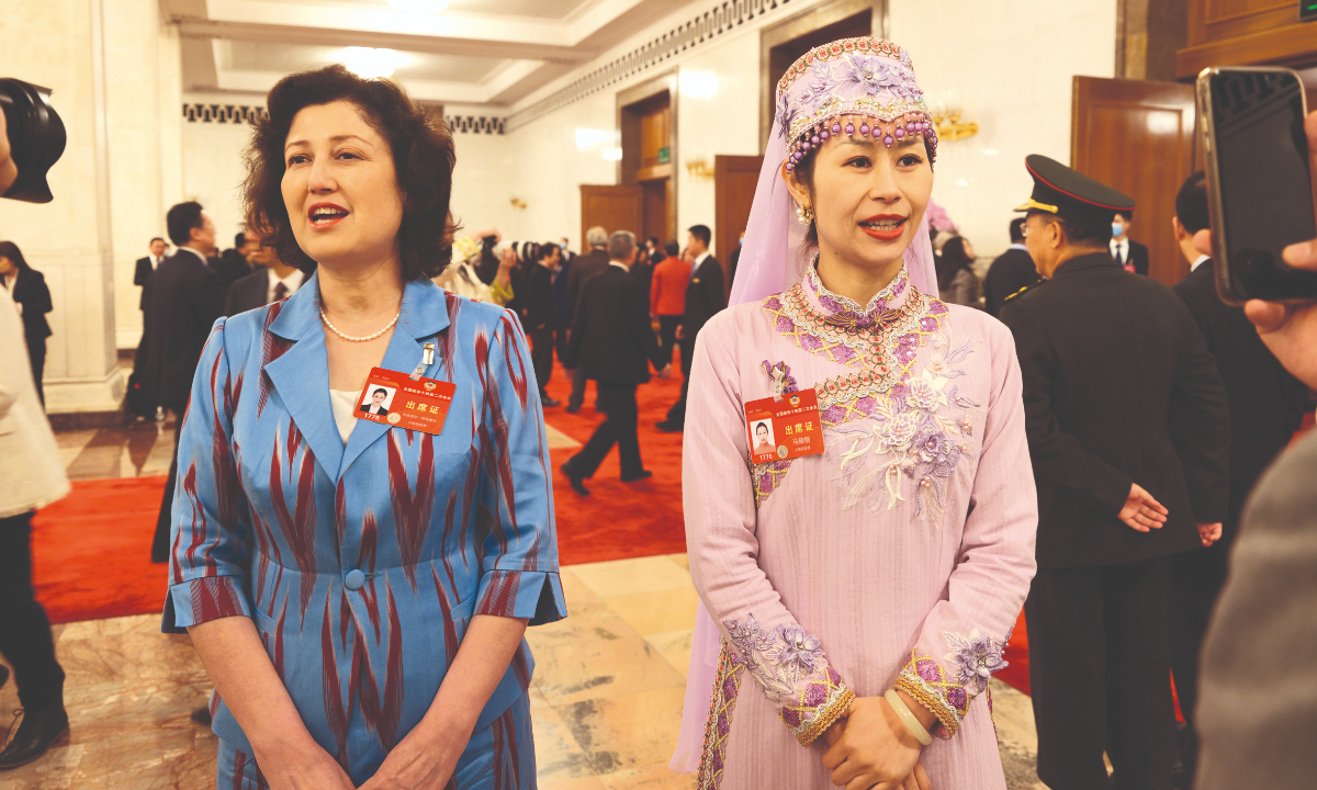 Muhebaier Abuduer (left) and Ma Xiaoli (right), two members of the 14th National Committee of the Chinese People's Political Consultative Conference (CPPCC), receive their passage interviews at the Great Hall of the People in Beijing on March 10, 2024. Photo: VCG