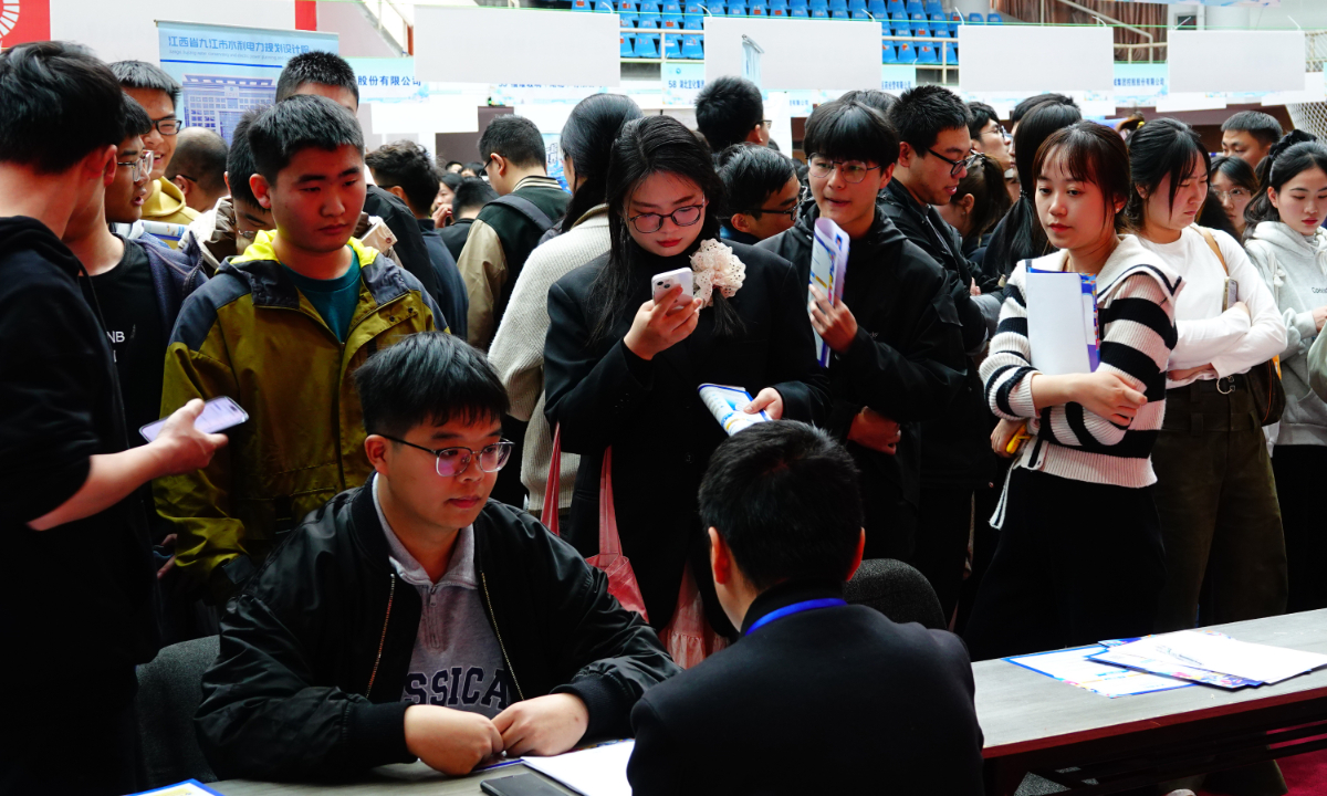College graduates attend a special job fair held in Sanxia University, Central China's Hubei Province on March 14, 2024. About 200 enterprises and public institutions joined the job fair that day, providing more than 7,000 job opportunities. Across China, it is expected that a total of 11.79 million college students will be graduated in 2024, a record high. Photo: VCG