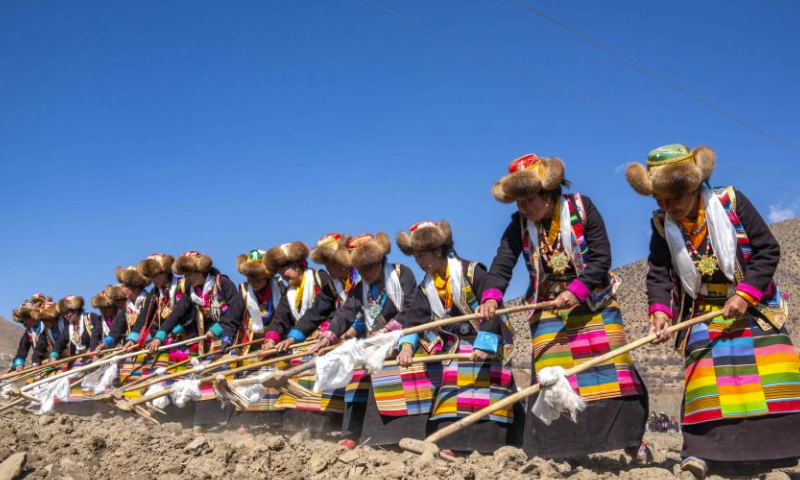 Farmers participate in a ceremony marking the start of spring farming in Gyaimain Village in Qonggyai County of Shannan, southwest China's Xizang Autonomous Region, March 16, 2024. Ceremonies marking the start of spring farming were held in Xizang on Saturday during which farmers held chema (a wooden box filled with colorful grains and barley flour, symbolizing good luck and prosperity in Tibetan culture), sang songs, and toasted each other with barley wine. The ceremony holds great significance as it marks the beginning of a new year's farming season and serves as a prayer for favorable weather and bountiful harvests. It is considered an important ritual in the farming regions of Xizang. (Xinhua/Tenzing Nima Qadhup)