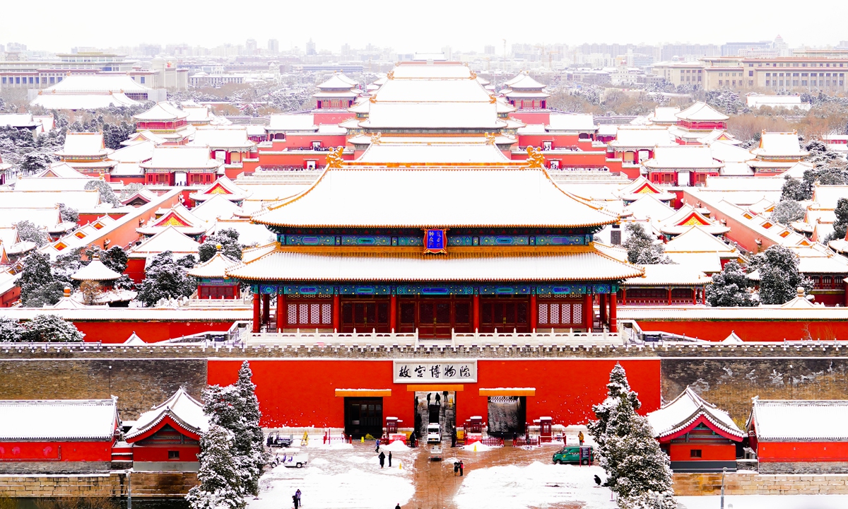 Tourists enjoy the scenery after snowfall at the Palace Museum in Beijing. Photo: VCG
