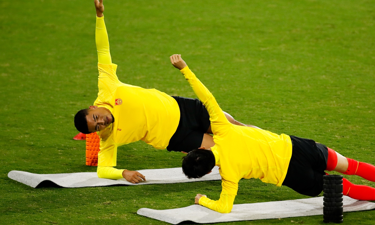 Chinese player Jiang Guangtai(left) stretches during the national soccer team’s first training session led by new head coach Branko Ivankovic in Shenzhen, South China’s Guangdong Province, on March 11, 2024. Team China will play an away match in Singapore on March 21 for their next FIFA World Cup qualifier.Photo: VCG