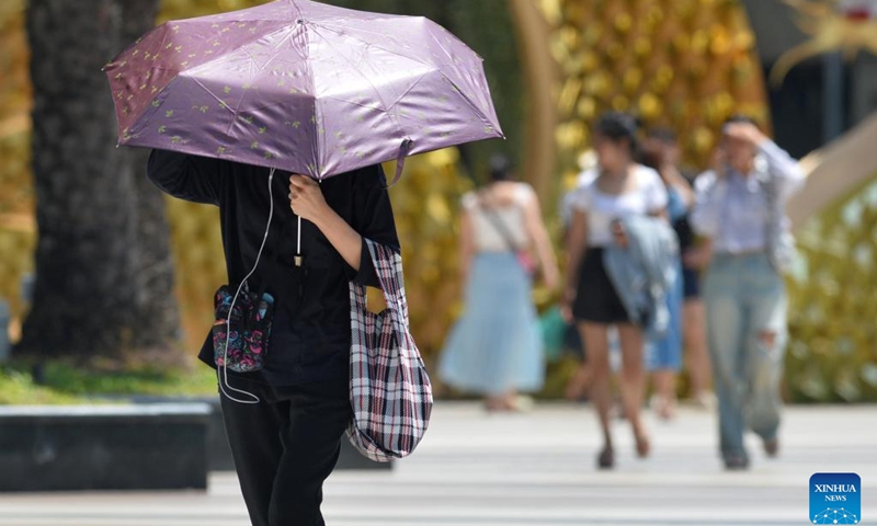 A pedestrian shields herself from the sun with an umbrella in Bangkok, Thailand, March 5, 2024.((Photo: Xinhua)