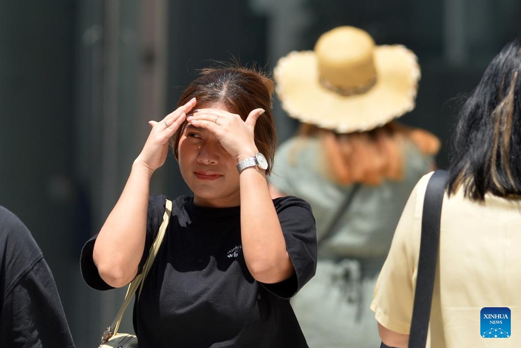 A pedestrian shades her face from the sun in Bangkok, Thailand, March 5, 2024.((Photo: Xinhua)
