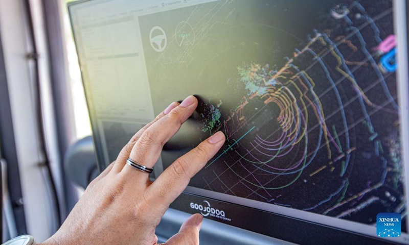 A staff member shows a radar map inside an autonomous electric bus powered by 5G technology in Ayutthaya, Thailand, March 5, 2024. An autonomous electric bus powered by 5G technology has recently started trial operation in the city of Ayutthaya. The bus seats 20 passengers and will end its trial run in July.(Photo: Xinhua)