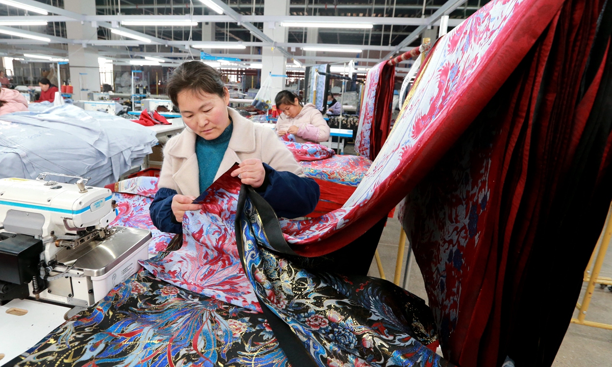 Female workers rush to make horse-face skirts in a factory in the Caoxian county, East China's Shandong Province, on March 4, 2024. The sales of horse-face skirt produced in the county reached around 400 million yuan ($55.6 million) in January 2024. Photo: VCG  