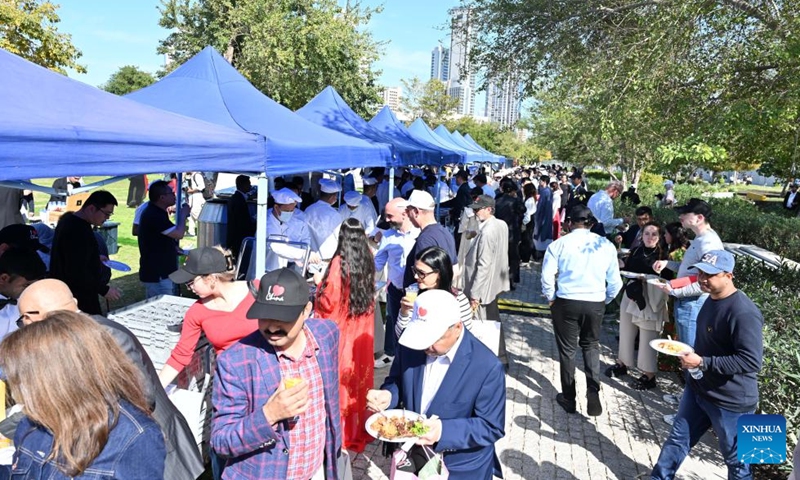 People taste Chinese food during the Chinese Culture and Food Festival at the Sheikh Jaber Al-Ahmad Cultural Centre in the Capital Governorate, Kuwait, on March 9, 2024. The Chinese Culture and Food Festival was held here on Saturday. (Photo by Asad/Xinhua)