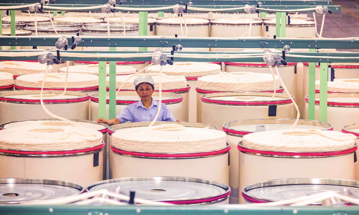 An employee works on an intelligent production line of a textile technology company in Taizhou, East China's Jiangsu Province on March 12, 2024. The company has accelerated the development of new quality productive forces, realizing a 10 percent drop in production costs per unit of output value and a 1.4-fold increase in production efficiency.Photo: VCG