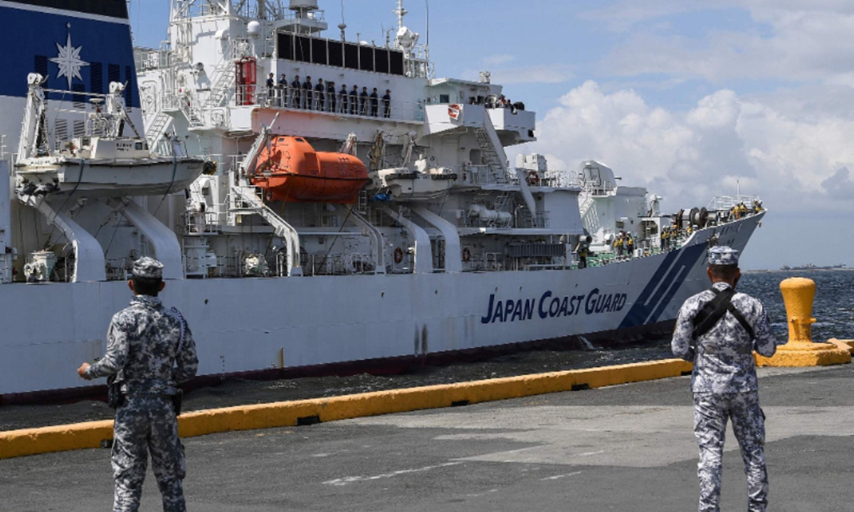 Philippine coast guard personnel stand guard as Japanese coast guard ship Akitsushima arrives at the international port in Manila on June 1, 2023, ahead of a joint maritime exercise with the Philippines and the US. Photo: VCG