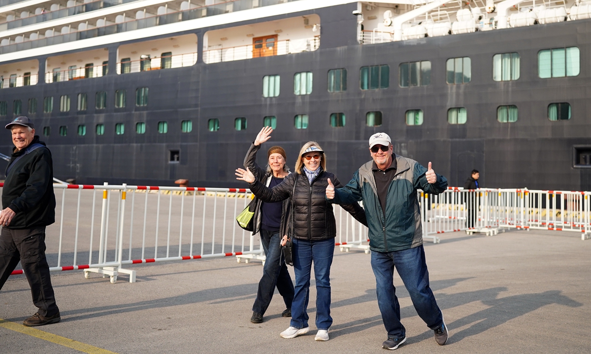 Passengers step down from the international cruise ship Zuiderdam, operated by Holland America Line, and pose happily for photos when the ship docks at Tianjin International Cruise Home Port in North China on March 11, 2024. Over 1,100 tourists from 30 countries and regions boarded the cruise ship. Photo: VCG