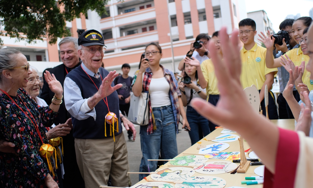 A Flying Tigers veteran waves to students at a school in Liuzhou, South China's Guangxi Zhuang Autonomous Region, on November 4, 2023. Photo: VCG