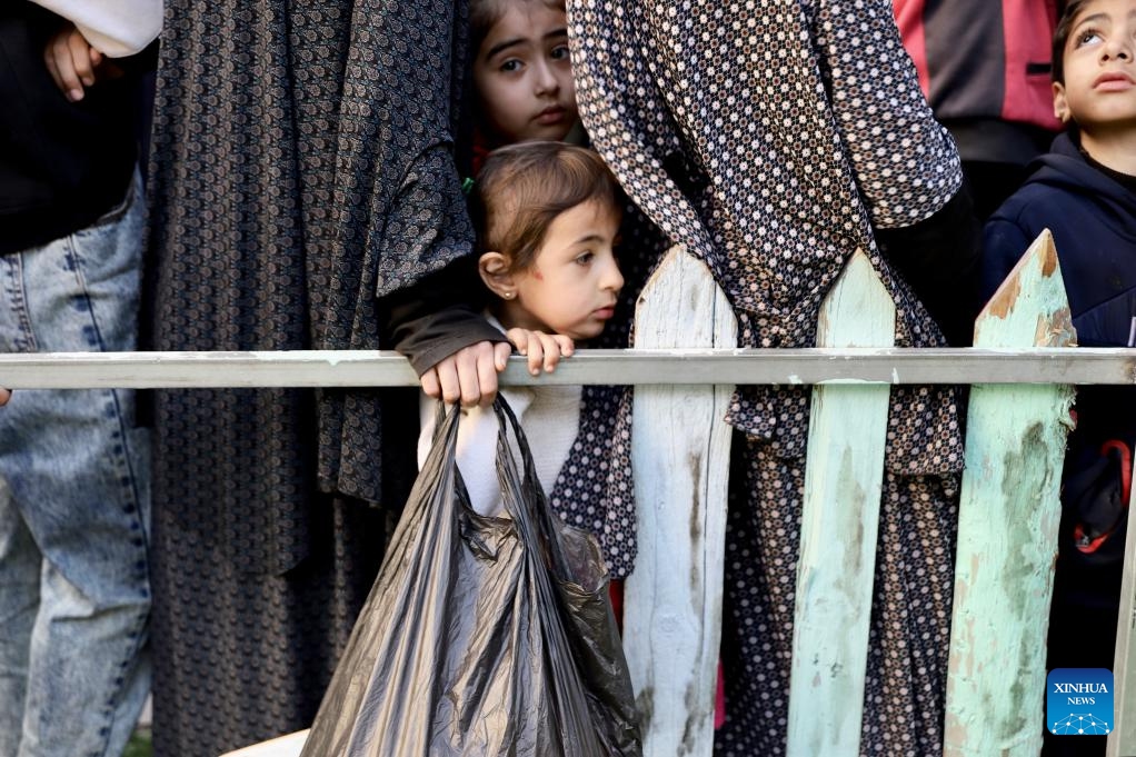 People wait to receive food relief during Ramadan in Gaza City, on March 13, 2024. The Palestinian death toll due to the ongoing Israeli attacks on the Gaza Strip has climbed to 31,272, reported the Gaza-based Health Ministry on Wednesday.(Photo: Xinhua)