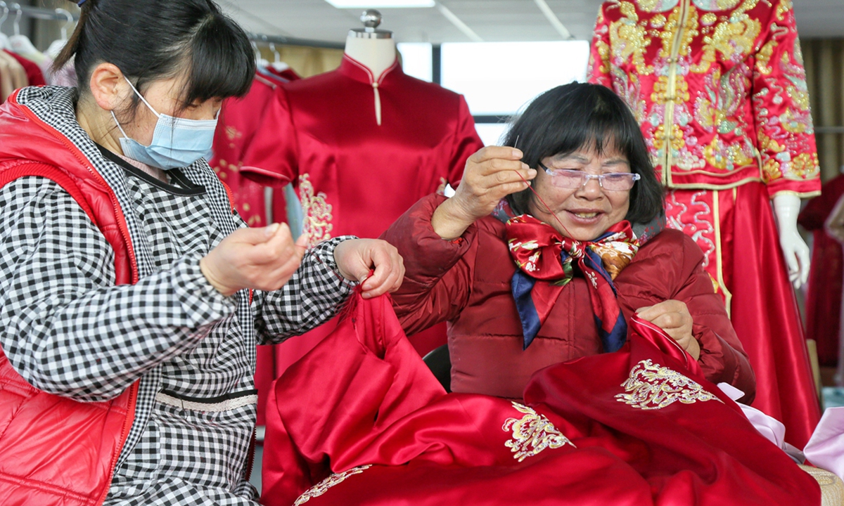 Two local women make cheongsam at a start-up in Jiangliu village, East China’s Nantong Province on March 17, 2024. The start-up, named “micro home for women,” aims to provide employment for local women.Cheongsams are hot sellers among the Chinese young generation. Sales of cheongsams jumped five times at e-commerce platform JD.com in the third quarter of 2023. Photo: VCG
