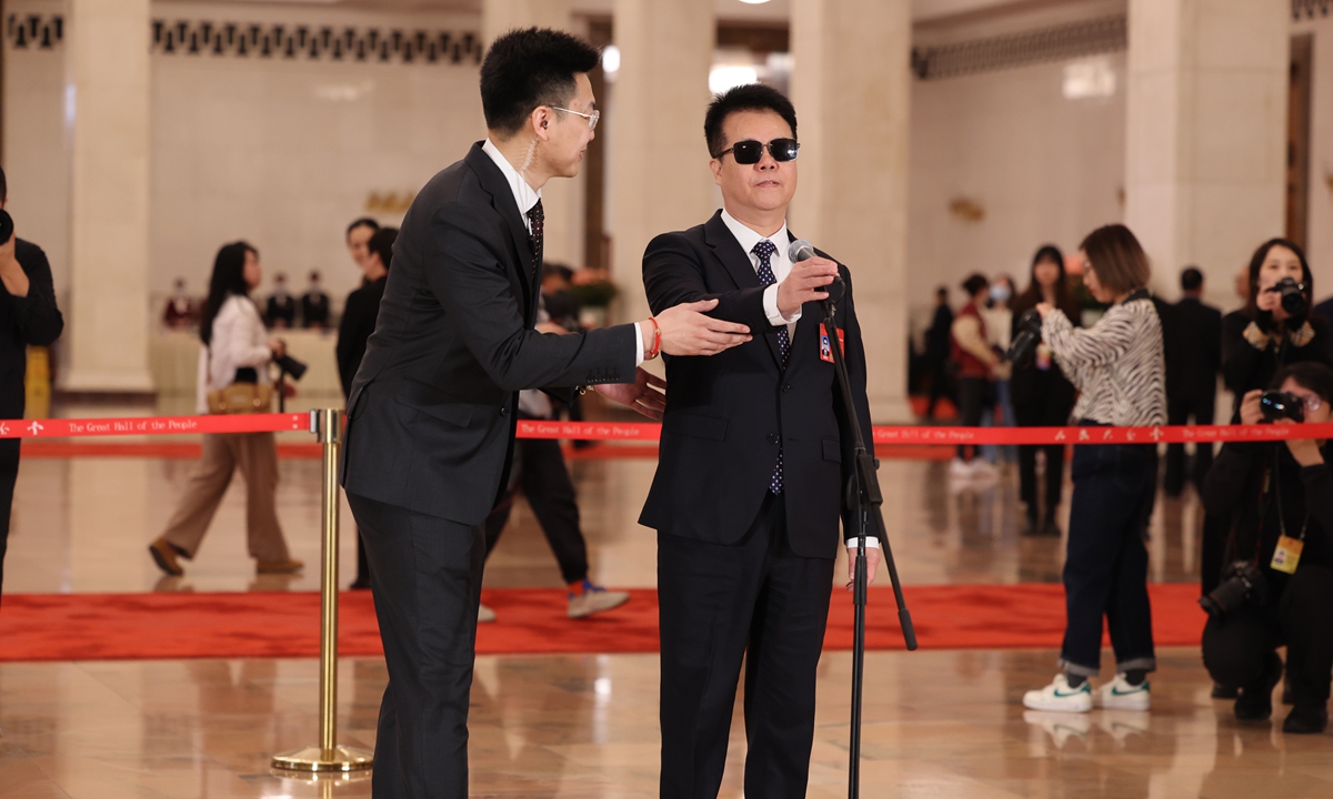 Wang Yongcheng (right) delivers a speech during the second session of the 14th National People's Congress in Beijing on March 8. Photos: VCG
