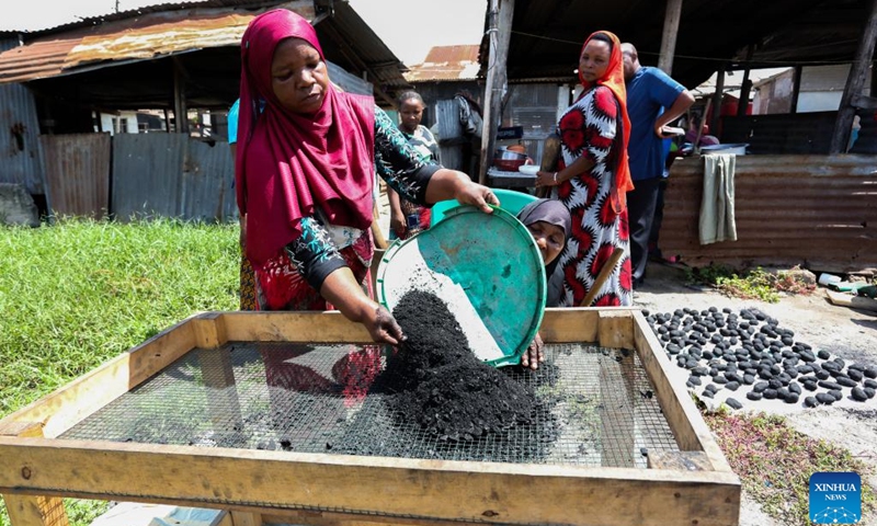 Members of a women's group use coconut shells, dried banana peels and dried cassava stalks to make charcoal at a street workshop in Dar es Salaam, Tanzania, on March 16, 2024.(Photo: Xinhua)