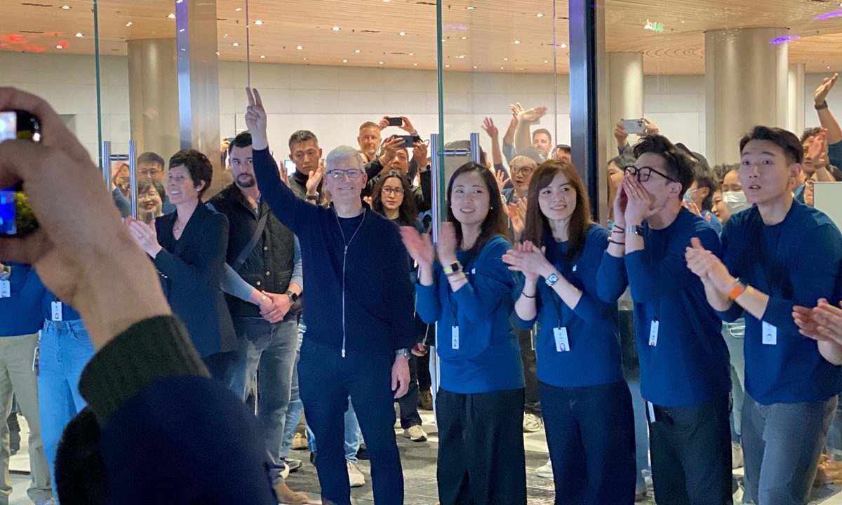 Apple CEO Tim Cook waves to crowds as he attends the opening ceremony of a new flagship store in Shanghai on March 21, 2024. It is the second-largest Apple flagship store after the one on Fifth Avenue in New York City. Cook also took pictures with customers on site and signed autographs. Photo: Chen Xia/GT
