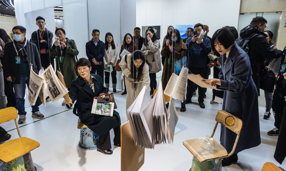 Visitors experience a book exhibition at The Song of the Earth: Artistic Documentary for a Better China exhibition at the China Millennium Monument's Beijing World Art Museum on March 20, 2024. Photo: Li Hao/GT