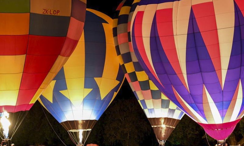 Hot air balloons illuminate during a night glow event in Hamilton, New Zealand, March 23, 2024. The 5-day annual balloon festival concluded on Saturday. (Xinhua/Guo Lei)