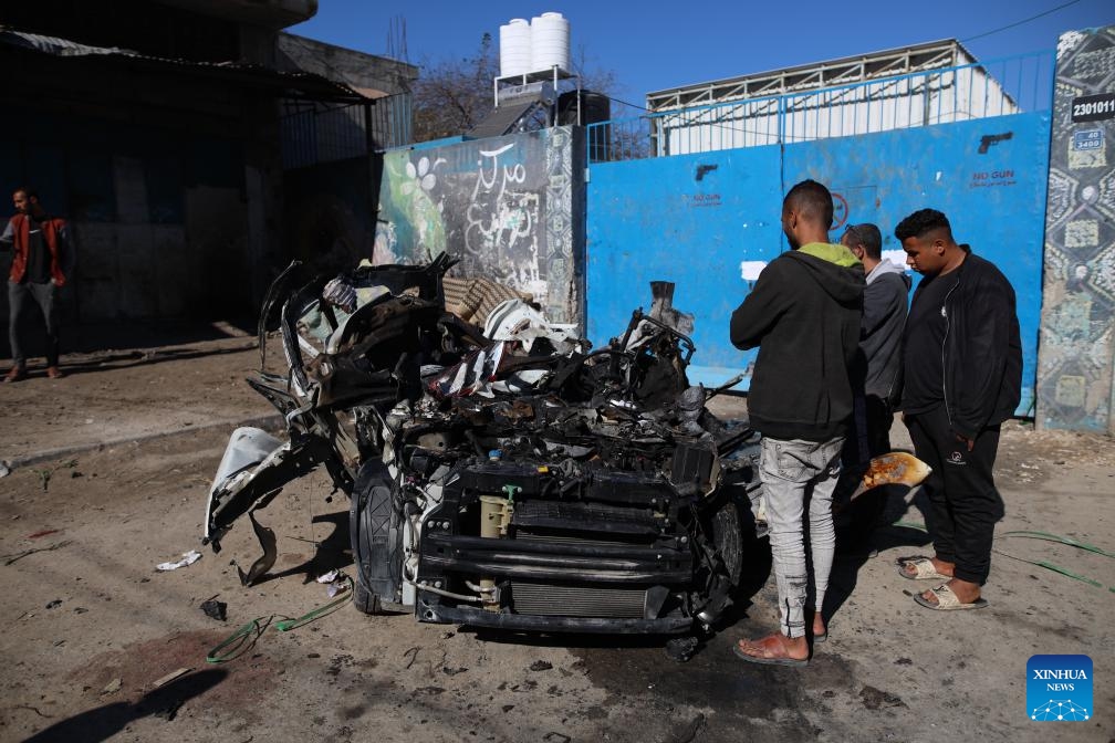 People gather around a destroyed vehicle after an Israeli airstrike in the Nuseirat refugee camp, central Gaza Strip, on March 20, 2024. The Palestinian death toll from the ongoing Israeli attacks in the Gaza Strip has risen to 31,923, with 74,096 others wounded, the Hamas-run Health Ministry said Wednesday.(Photo: Xinhua)