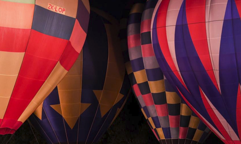Hot air balloons illuminate during a night glow event in Hamilton, New Zealand, March 23, 2024. The 5-day annual balloon festival concluded on Saturday. (Xinhua/Guo Lei)