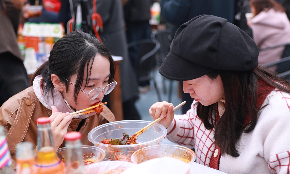 Two women enjoy <em>malatang</em> at a foodie festival in Tianshui, Gansu, on March 16, 2024. Photo: VCG