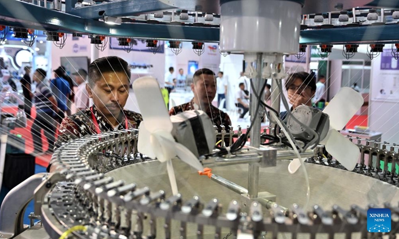 An exhibitor prepares to demonstrate a knitting machine during INDO INTERTEX, a major textile and garment exhibition, at Jakarta International Expo, Jakarta, Indonesia, on March 21, 2024. From March 20 to 23, more than 600 companies attend INDO INTERTEX, showcasing their newest advancements in digital printing, textile chemistry, raw materials, digital technology, apparel, accessories, and other textile products.(Photo: Xinhua)