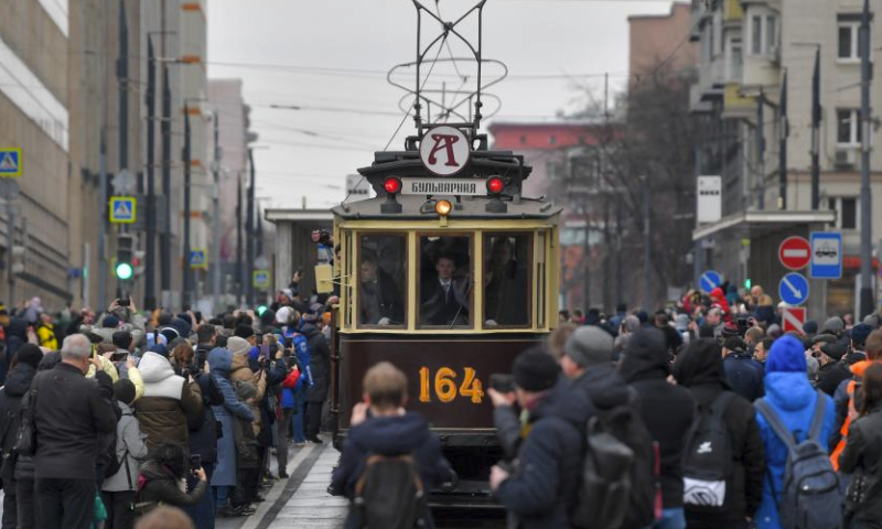 People watch a parade of retro tramways in Moscow, Russia, on April 6, 2024. The parade of retro tramways was held on Saturday to mark the 125th anniversary of the opening of the first tram line in Moscow. (Photo by Alexander Zemlianichenko Jr/Xinhua)