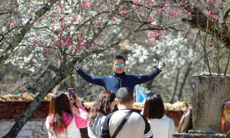 A man poses for photos at a homestay in Danba County, Tibetan Autonomous Prefecture of Garze, southwest China's Sichuan Province, March 23, 2024. Danba County has rolled out policies to support the development of the homestay industry and accelerate the high-quality development of the cultural tourism industry. (Xinhua/Shen Bohan)