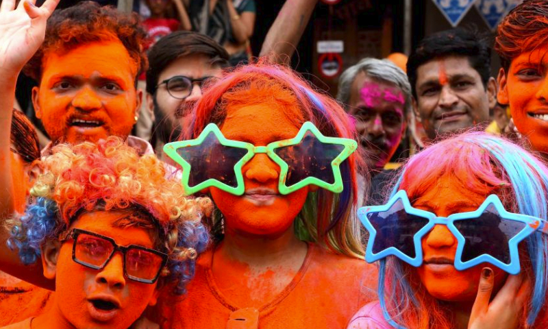 People smeared with colored powder take part in a celebration of the Rang Panchami festival in Indore, Madhya Pradesh state, India, March 30, 2024. (Str/Xinhua)
