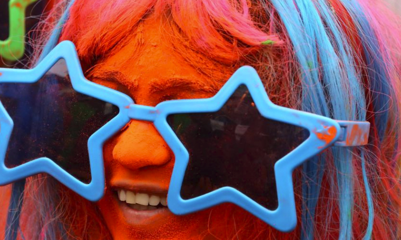 A woman smeared with colored powder takes part in a celebration of the Rang Panchami festival in Indore, Madhya Pradesh state, India, March 30, 2024. (Str/Xinhua)