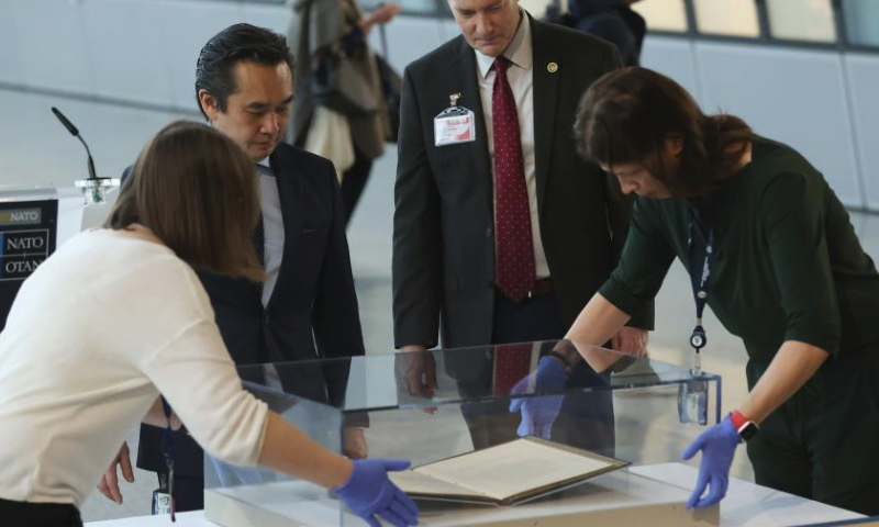 North Atlantic Treaty Organization (NATO) staff members place the original copy of the North Atlantic Treaty for display before a ceremony to mark the 75th anniversary of NATO at the NATO headquarters in Brussels, Belgium, April 4, 2024. NATO marked the 75th anniversary since the signing of the North Atlantic Treaty on Thursday. (Xinhua/Zhao Dingzhe)