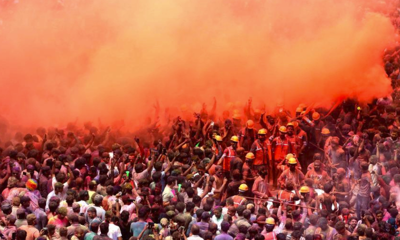 People smeared with colored powder take part in a celebration of the Rang Panchami festival in Indore, Madhya Pradesh state, India, March 30, 2024. (Str/Xinhua)