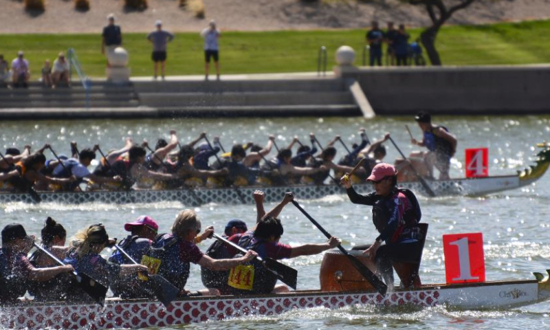 Participants compete on the Tempe Town Lake in Tempe, Arizona, the United States, March 23, 2024. The 18th Annual Arizona Dragon Boat Festival, hosted by Arizona Dragon Boat Association, was held on March 23 and 24. (Photo by Sui Xuguang/Xinhua)