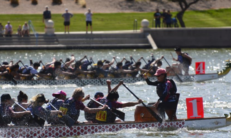Participants compete on the Tempe Town Lake in Tempe, Arizona, the United States, March 23, 2024. The 18th Annual Arizona Dragon Boat Festival, hosted by Arizona Dragon Boat Association, was held on March 23 and 24. (Photo by Sui Xuguang/Xinhua)