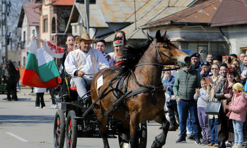 People in horse driven carts participate in a horse beauty parade during the celebration of the traditional Tudorita holiday, also known as the Easter of Horses, in Targoviste, 80 km north of Bucharest, Romania, March 23, 2024. Easter of Horses is celebrated by the local Bulgarian community and symbolizes the start of agricultural work in the new year. (Photo by Cristian Cristel/Xinhua)