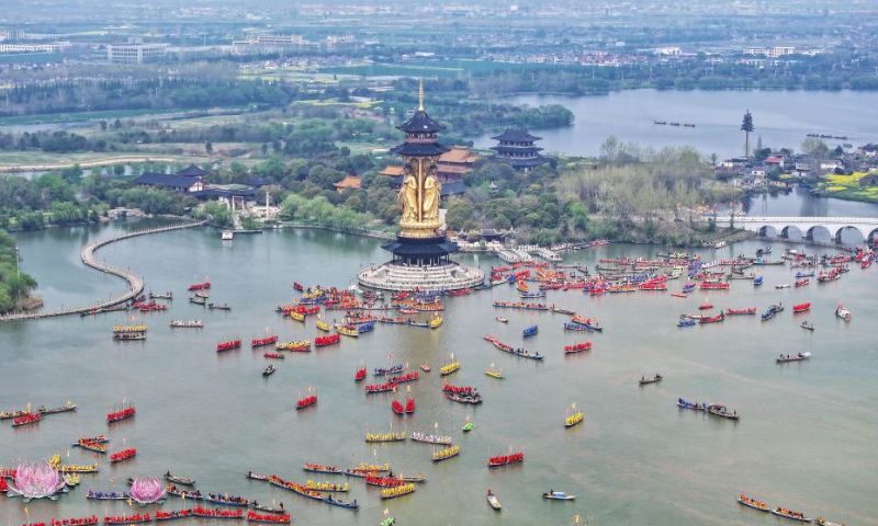 An aerial drone photo taken on April 6, 2024 shows people participating in a boat performance during the 2024 Qintong Boat Festival held at Qinhu National Wetland Park in Jiangyan District of Taizhou, east China's Jiangsu Province. Hundreds of boats with more than 10,000 boat team members aboard gathered here on Saturday for the Qintong Boat Festival, which has been a centuries-old tradition. (Photo by Gu Jihong/Xinhua)