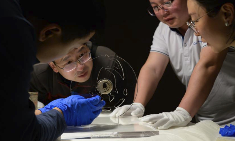 Staff members make preparations for display of the jade phoenix at the Panlongcheng Site Museum in Wuhan, central China's Hubei Province, March 30, 2024. The jade phoenix, which has been kept by the National Museum of China, was introduced to the exhibition Mythological Jade of Shijiahe Culture at the Panlongcheng Site Museum in Wuhan on Saturday.
This is the first time that the jade phoenix has returned to Hubei since it was unearthed at the Shijiahe site in Tianmen of Hubei in 1955. (Xinhua/Hu Jingwen)
