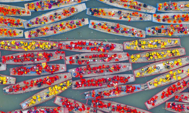 An aerial drone photo taken on April 6, 2024 shows people participating in a boat performance during the 2024 Qintong Boat Festival held at Qinhu National Wetland Park in Jiangyan District of Taizhou, east China's Jiangsu Province. Hundreds of boats with more than 10,000 boat team members aboard gathered here on Saturday for the Qintong Boat Festival, which has been a centuries-old tradition. (Photo by Tang Dehong/Xinhua)