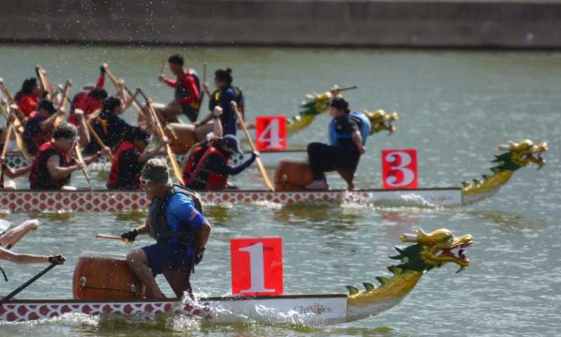 Participants compete on the Tempe Town Lake in Tempe, Arizona, the United States, March 23, 2024. The 18th Annual Arizona Dragon Boat Festival, hosted by Arizona Dragon Boat Association, was held on March 23 and 24. (Photo by Sui Xuguang/Xinhua)
