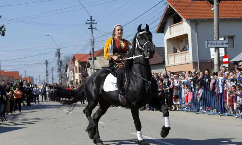 A woman rides her horse on a horse-beauty parade during the celebration of the traditional Tudorita holiday, also known as the Easter of Horses, in Targoviste, 80 km north of Bucharest, Romania, March 23, 2024. Easter of Horses is celebrated by the local Bulgarian community and symbolizes the start of agricultural work in the new year. (Photo by Cristian Cristel/Xinhua)