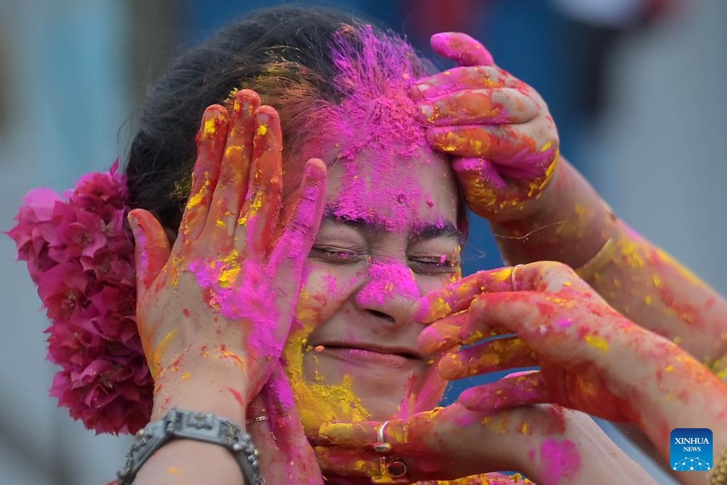 A woman smeared with colored powder is pictured during the celebration to mark Holi, the spring festival of colors, in Agartala, the capital city of India's northeastern state of Tripura, March 24, 2024.(Photo: Xinhua)