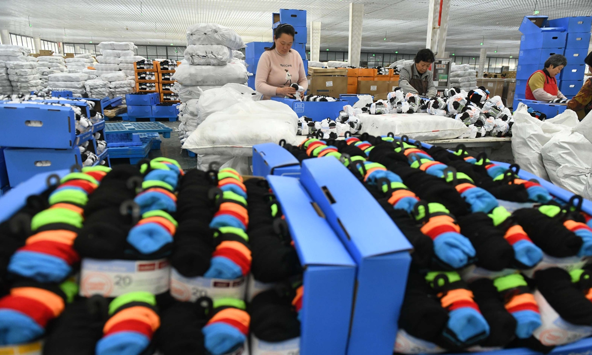 Workers make socks of various kinds at a plant in Fuyang, East China's Anhui Province on March 28, 2024. The city is building an industry cluster centered around socks production. In the first two months, China's apparel exports totaled $23.38 billion, up 13.1 percent year-on-year. Photo: cnsphoto 